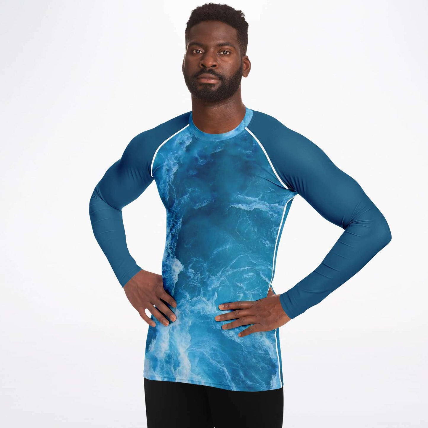 Male model wearing scuba diving rash guard with ocean design on front and back and blue sleeves