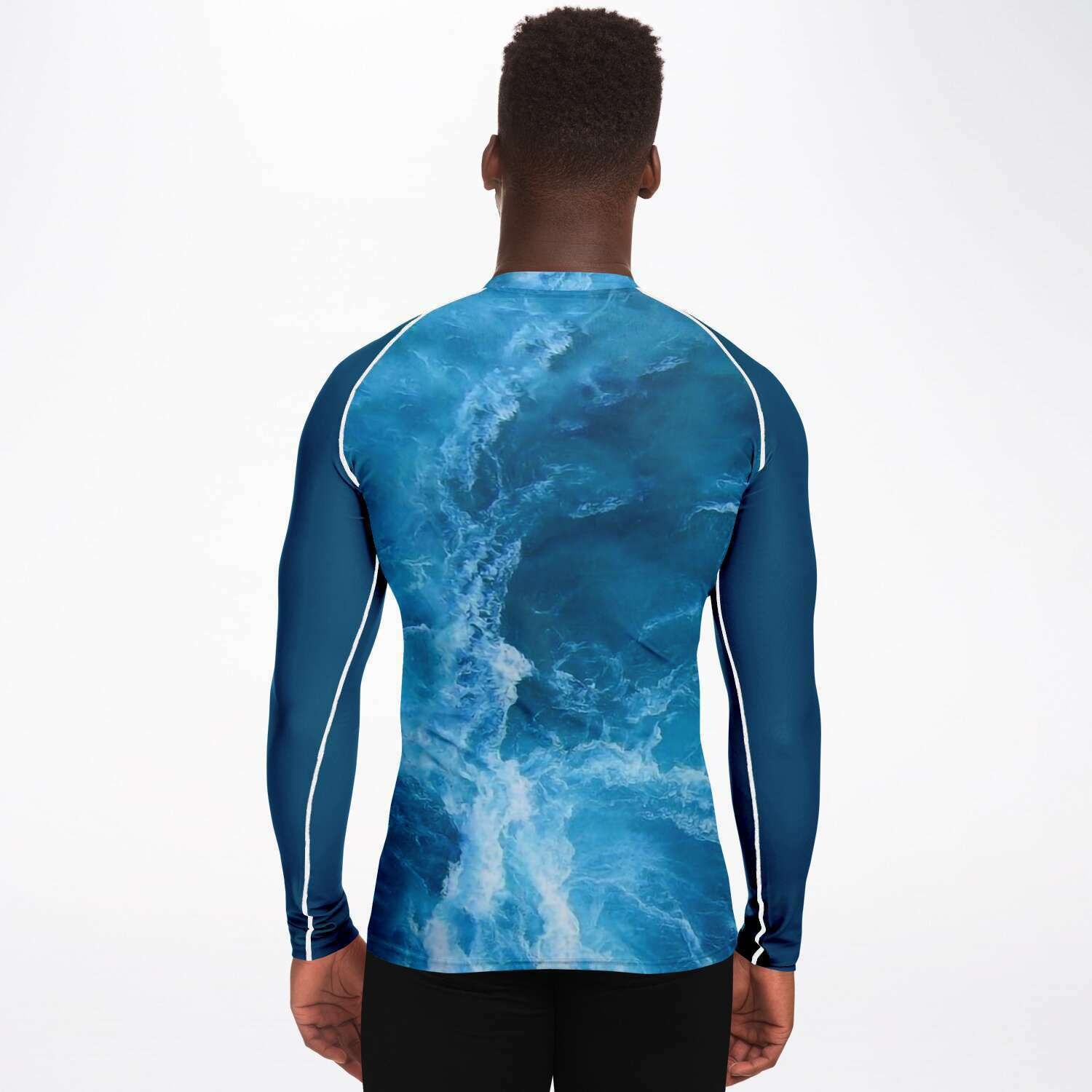 Male model back view wearing ocean patterned (front and back) scuba diving rash guard with blue sleeves