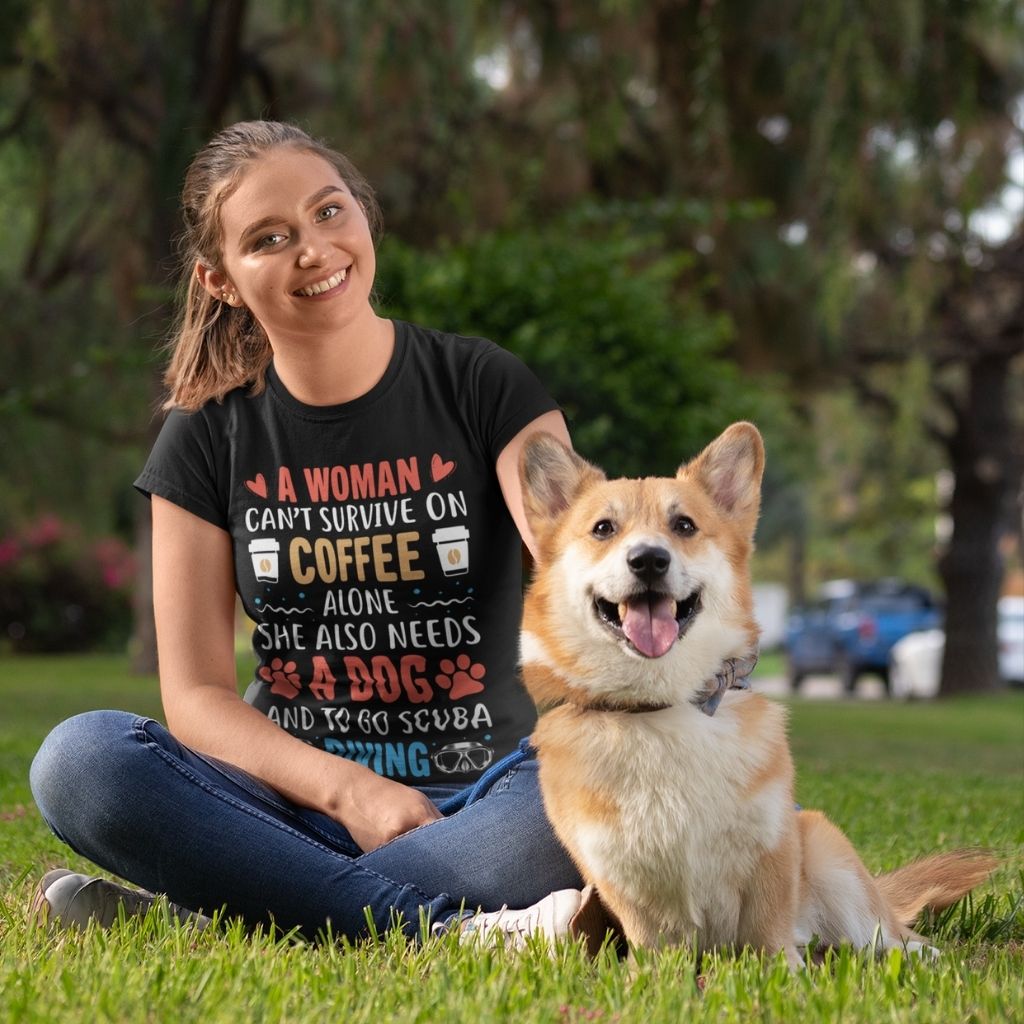 A woman can’t survive on coffee alone she also needs a dog and to go scuba diving tshirt worn by young woman in park with a corgi