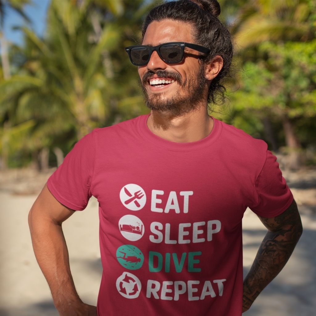 Eat sleep dive repeat red scuba diving tshirt worn by a man with sunglasses at the beach