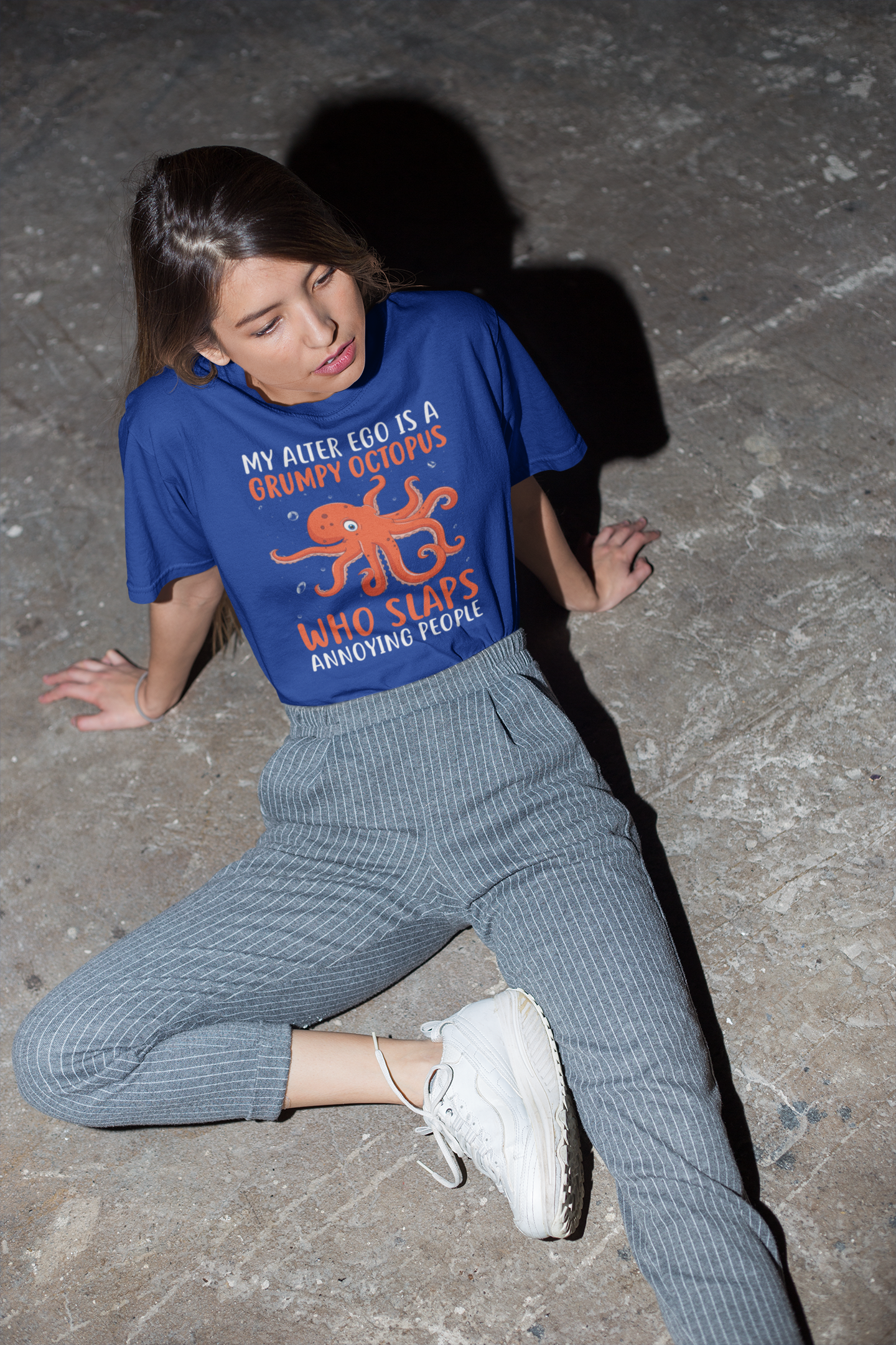 My alter ego is a grumpy octopus who slaps annoying people blue humorous t-shirt worn by woman with striped trousers