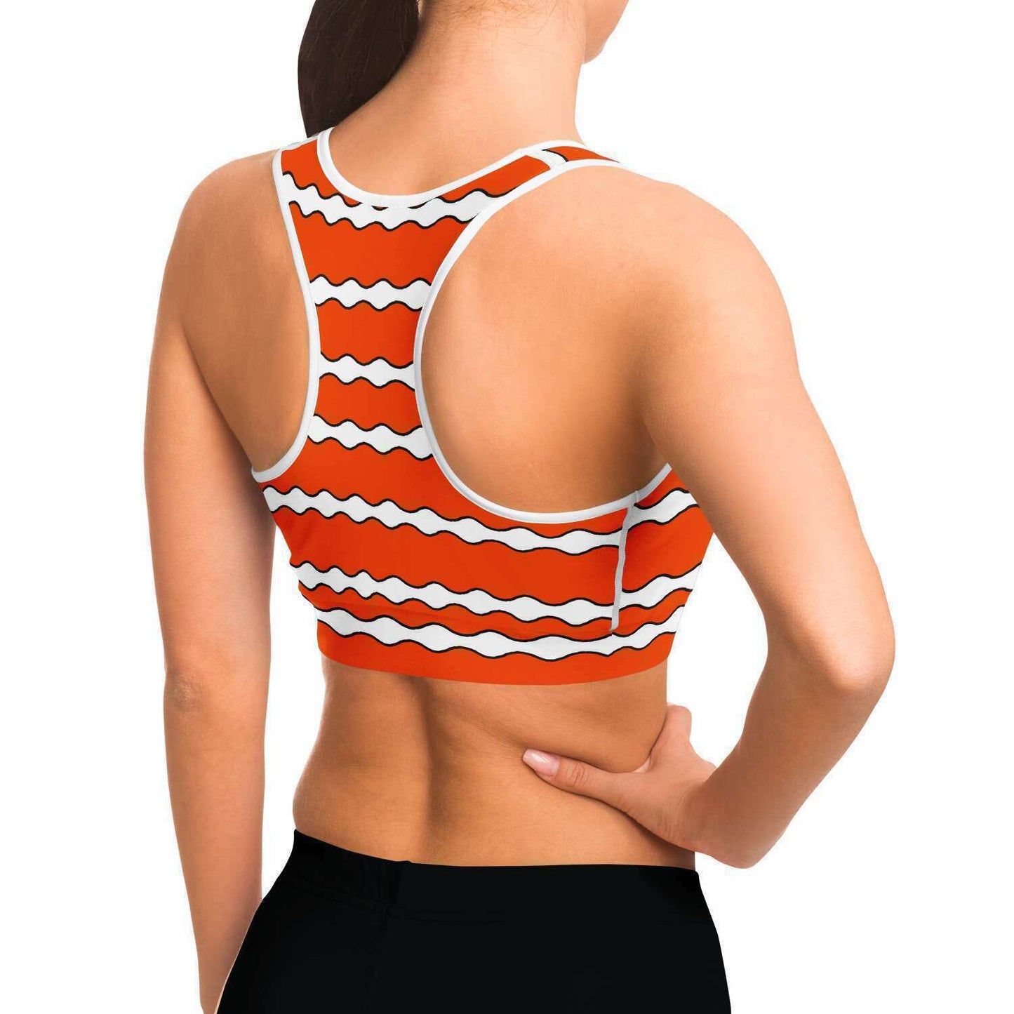 Side and back view of model wearing a clownfish racer-back crop top / sports bra so can see white stitching under the arm